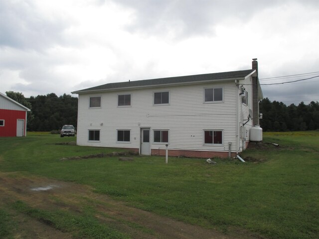 back of house featuring a lawn