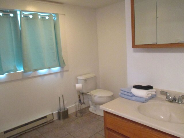 bathroom with tile flooring, a baseboard radiator, toilet, and vanity