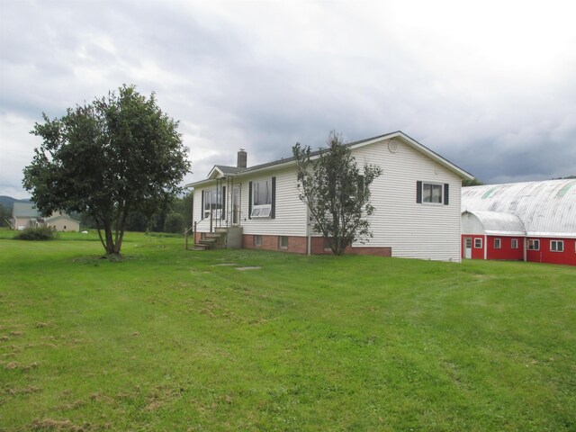 back of property featuring a lawn