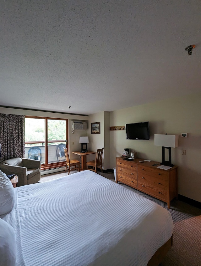 carpeted bedroom with a textured ceiling, a wall mounted AC, and a baseboard radiator