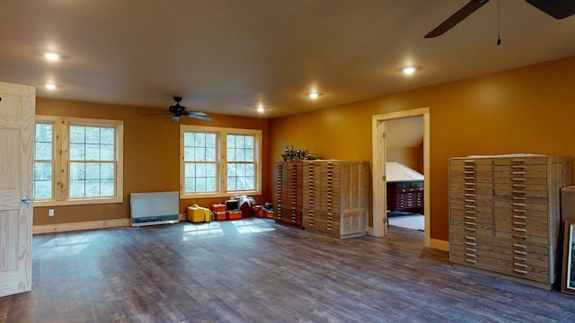 interior space featuring ceiling fan and dark wood-type flooring