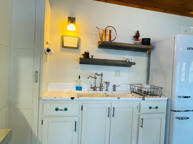 43 Jackson Lodge Rd, Canaan, VT 05903 - bar with white cabinetry, white fridge, and sink