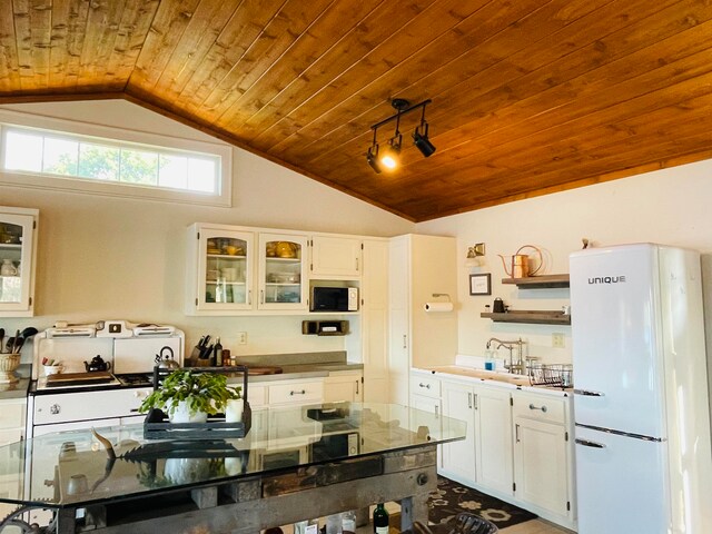 43 Jackson Lodge Rd, Canaan, VT 05903 - kitchen with lofted ceiling, wooden ceiling, white cabinetry, and white fridge