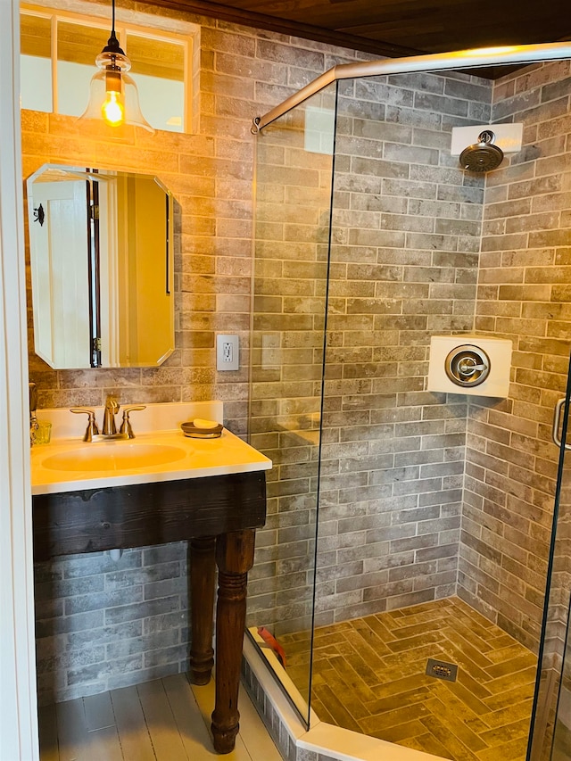 43 Jackson Lodge Rd, Canaan, VT 05903 - bathroom with brick wall, a shower with shower door, and vanity