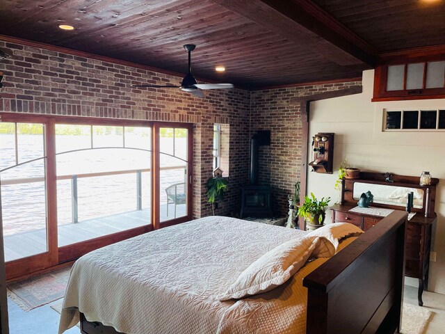 43 Jackson Lodge Rd, Canaan, VT 05903 - bedroom featuring wooden ceiling, multiple windows, a wood stove, and brick wall