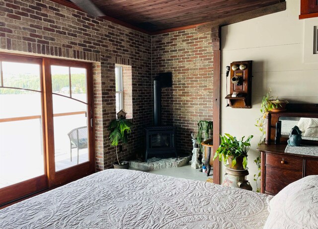 43 Jackson Lodge Rd, Canaan, VT 05903 - bedroom with brick wall, access to exterior, a wood stove, and wood ceiling