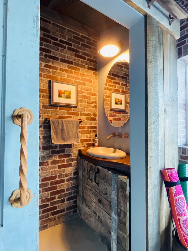 43 Jackson Lodge Rd, Canaan, VT 05903 - bathroom featuring brick wall and large vanity