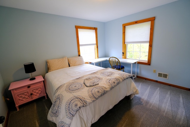 carpeted bedroom with visible vents and baseboards