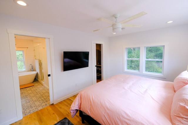 bedroom featuring recessed lighting, light wood finished floors, and multiple windows