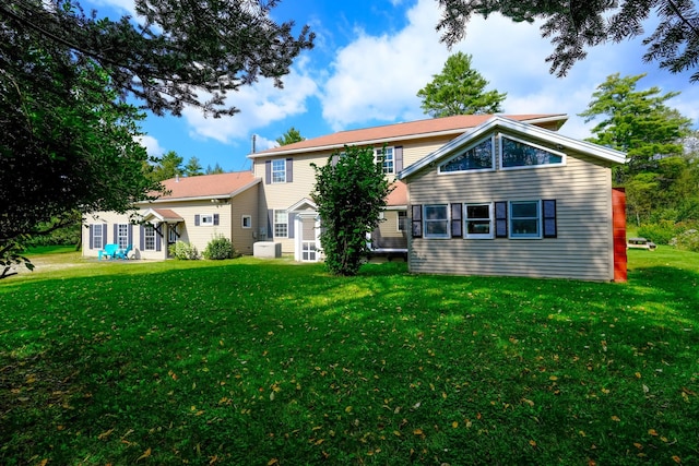 rear view of property featuring a yard