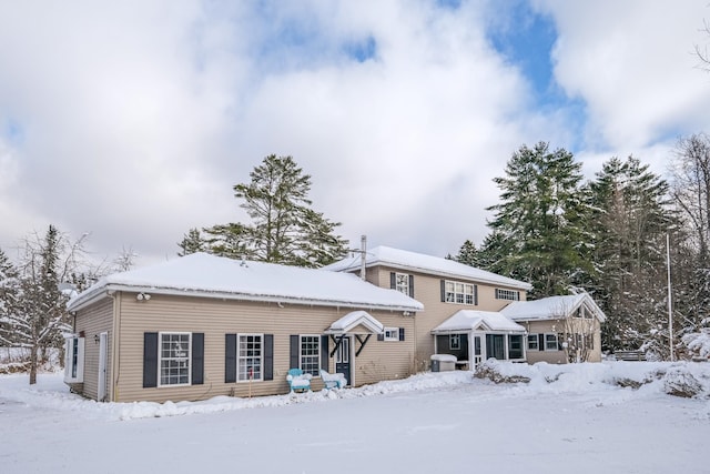 view of snow covered rear of property