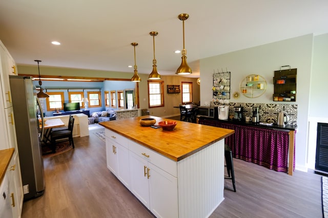 kitchen featuring butcher block countertops, appliances with stainless steel finishes, dark wood-type flooring, and white cabinets