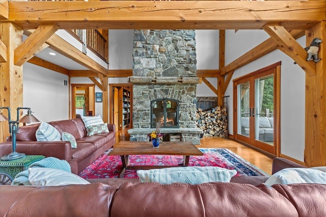 living room with beamed ceiling, hardwood / wood-style floors, and a fireplace