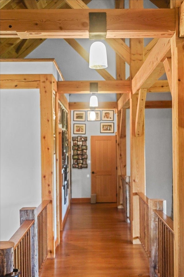 hallway with hardwood / wood-style floors and beamed ceiling