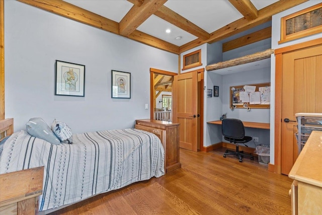 bedroom with beam ceiling, coffered ceiling, and dark wood-type flooring