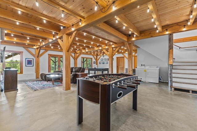 game room featuring beam ceiling, wooden ceiling, and washing machine and dryer