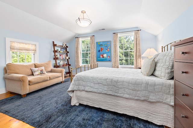 bedroom featuring lofted ceiling and hardwood / wood-style floors