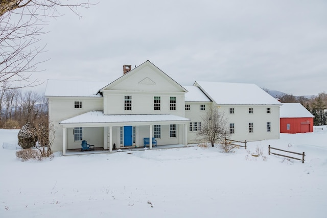 snow covered house with covered porch