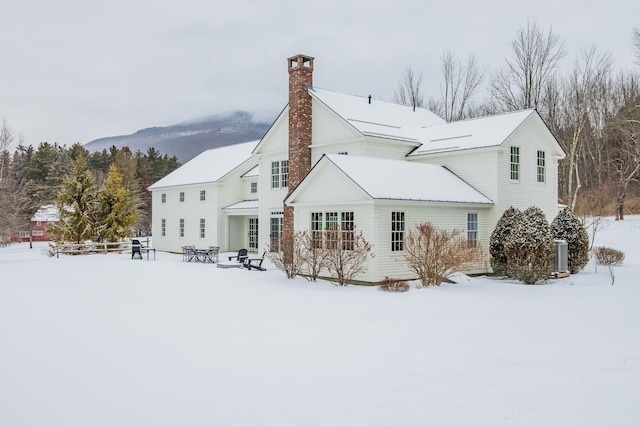 view of snow covered rear of property