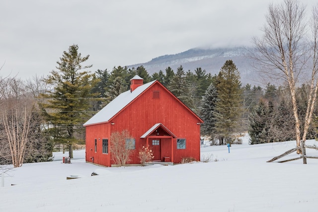 snow covered structure with a mountain view