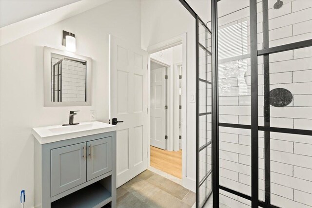 bathroom featuring hardwood / wood-style floors and oversized vanity