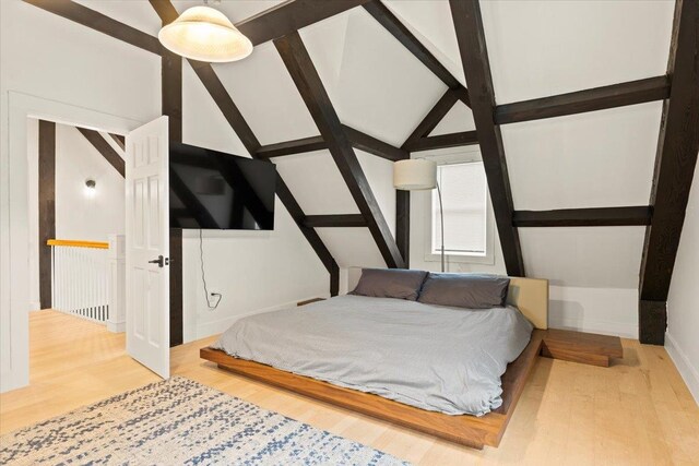 bedroom featuring lofted ceiling and light hardwood / wood-style floors