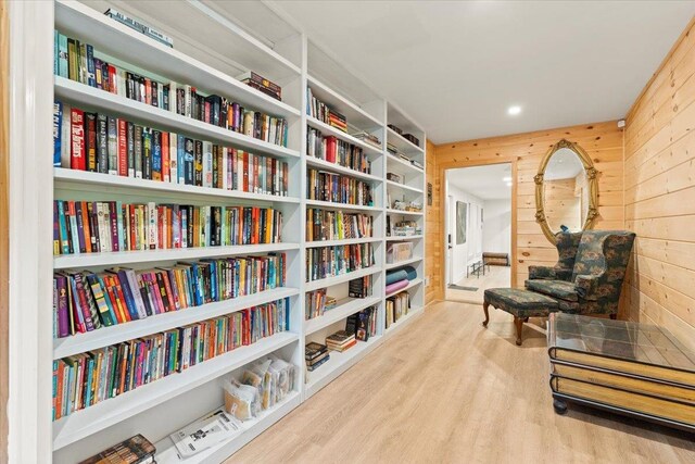 living area featuring wood walls and light wood-type flooring