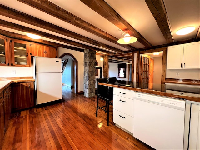 kitchen with white appliances, white cabinetry, dark wood-type flooring, and beam ceiling