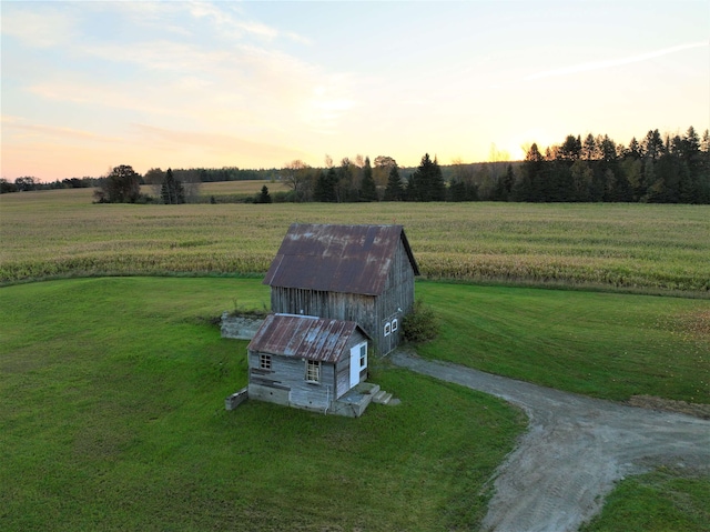 aerial view at dusk featuring a rural view