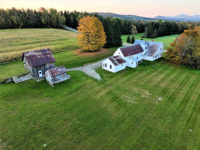 aerial view at dusk featuring a rural view