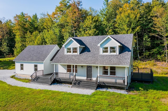 new england style home with a deck and a front lawn