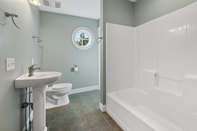 bathroom featuring washtub / shower combination, toilet, and tile floors