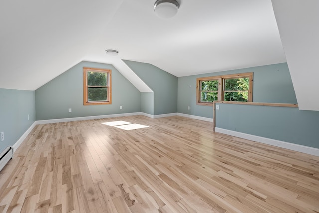 additional living space with lofted ceiling and light wood-type flooring