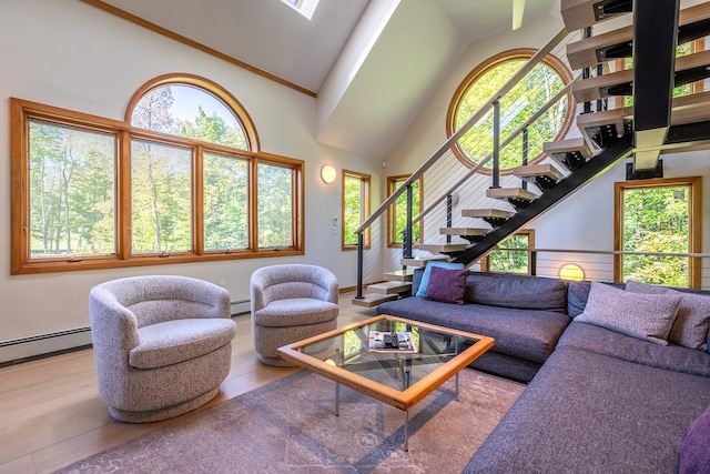 living room with high vaulted ceiling, light wood-type flooring, and a wealth of natural light