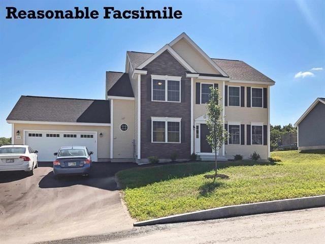 view of front of home with a front lawn and a garage