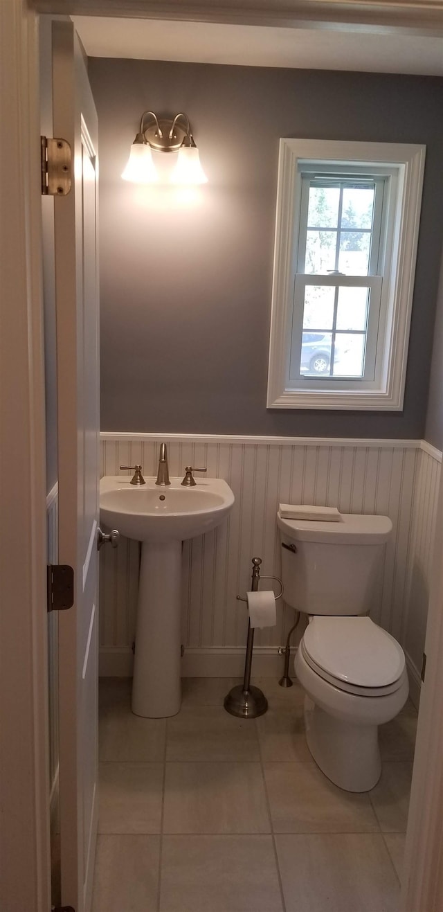 bathroom featuring sink, toilet, and tile patterned floors