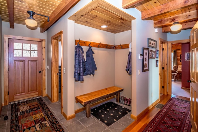 mudroom featuring tile patterned floors, beam ceiling, and wooden ceiling