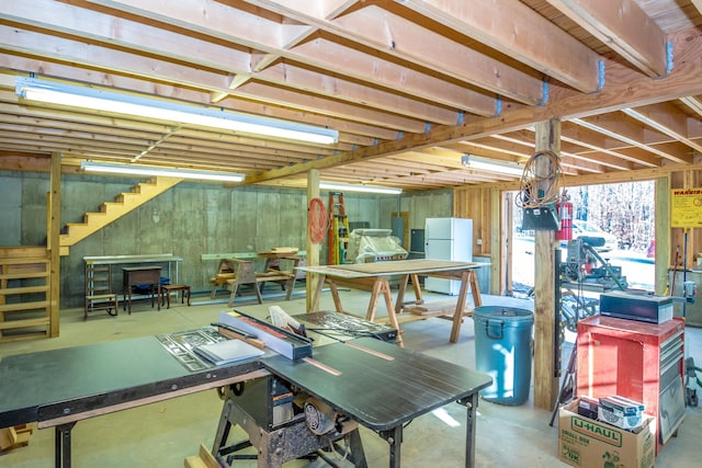 basement featuring white fridge