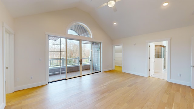 empty room featuring high vaulted ceiling, light hardwood / wood-style floors, and ceiling fan