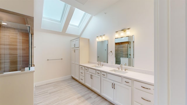 bathroom featuring vanity, an enclosed shower, hardwood / wood-style flooring, and vaulted ceiling with skylight