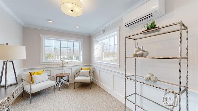 sitting room with crown molding, an AC wall unit, and a healthy amount of sunlight