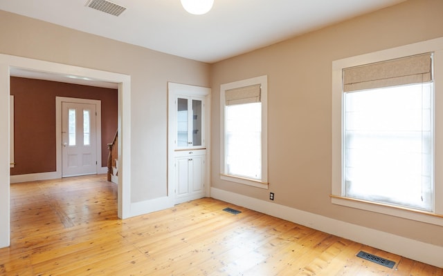 spare room with light hardwood / wood-style flooring