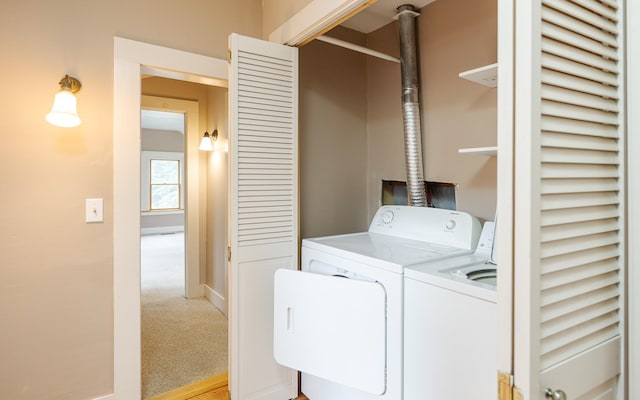 washroom with independent washer and dryer and light carpet