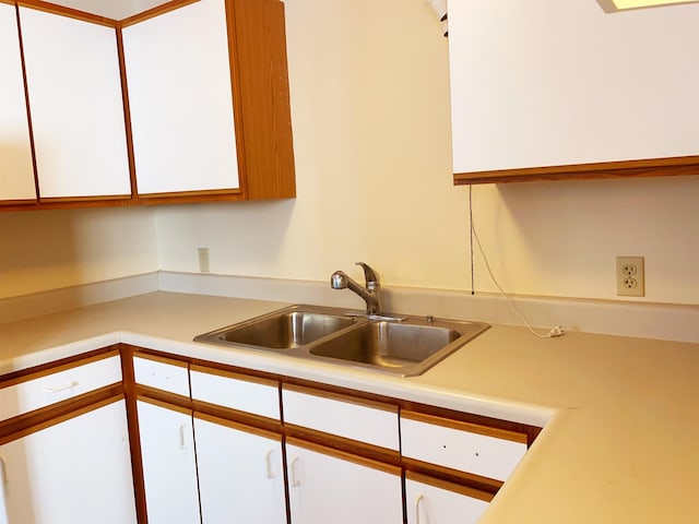 kitchen featuring sink and white cabinets