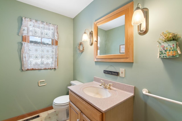 bathroom with visible vents, vanity, and toilet