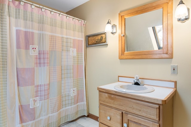 full bathroom featuring a shower with shower curtain, a skylight, and vanity