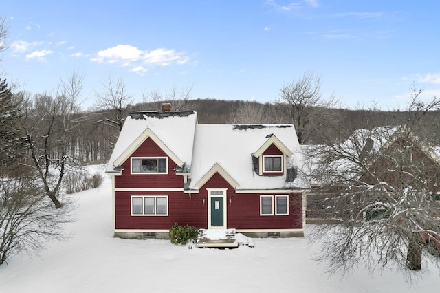 view of front of home featuring crawl space and a chimney