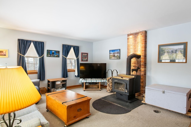 living room featuring carpet floors and a wood stove