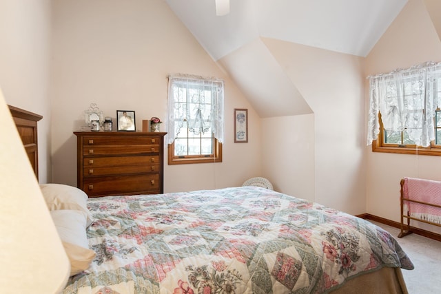 bedroom featuring carpet floors, lofted ceiling, baseboards, and a ceiling fan