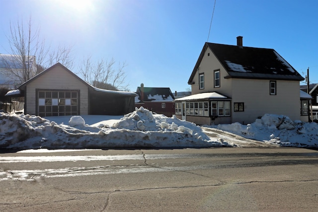 snow covered property featuring a chimney